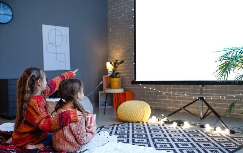 Little girls watching a movie at home 